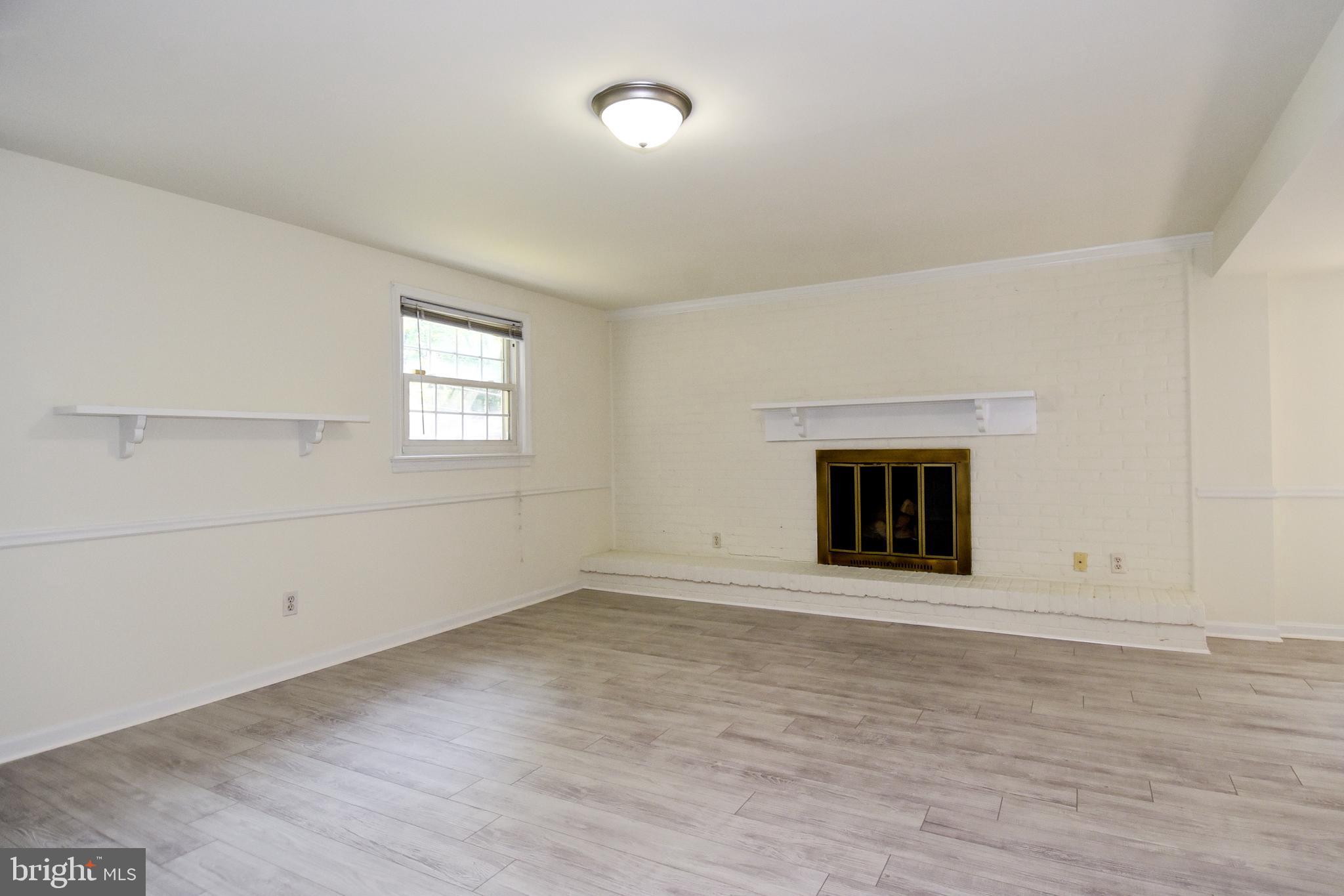 7513 Sebago Road Bethesda, MD 20817 - Photo 33 of 48 Lower level family room with woodburning fireplace