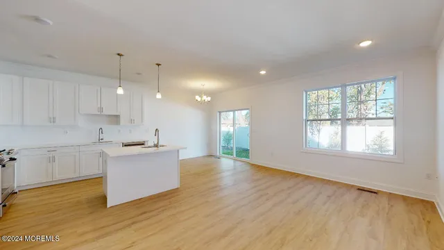 a view of kitchen with sink and wooden floor