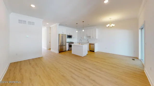 a view of a kitchen with a sink and a refrigerator