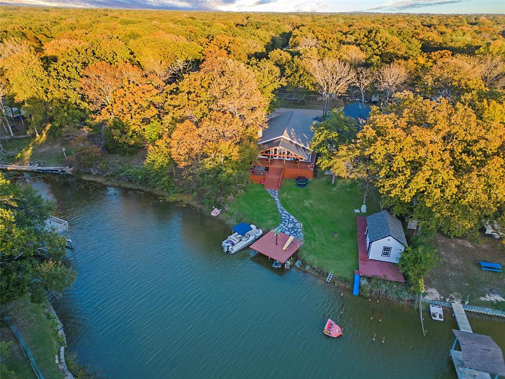 an aerial view of residential houses with outdoor space and swimming pool