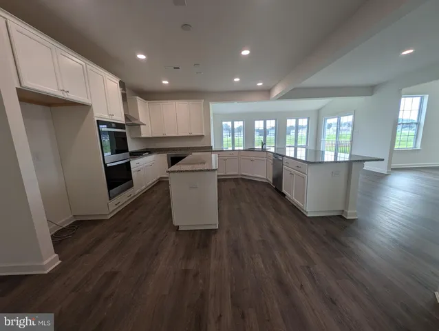 a view of a room with wooden floor and white walls