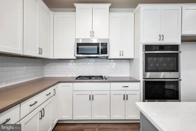 a bathroom with a tub a sink and a large mirror