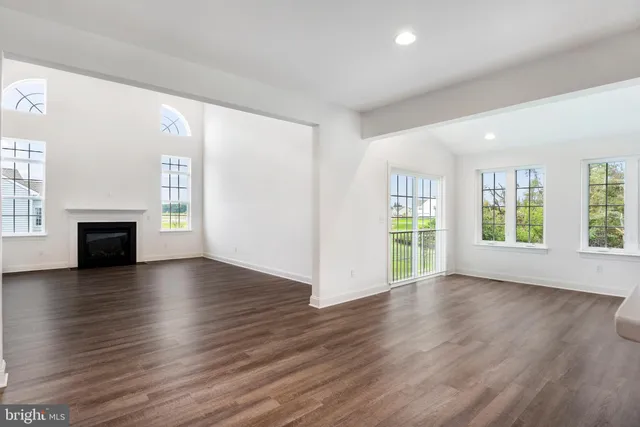a bathroom with a shower a toilet and a window