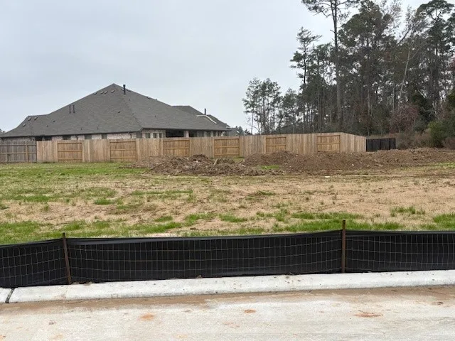 a view of swimming pool with a garden and plants