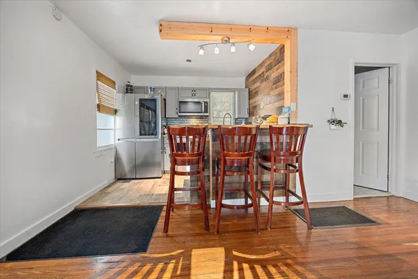 a view of a dining room with furniture and wooden floor