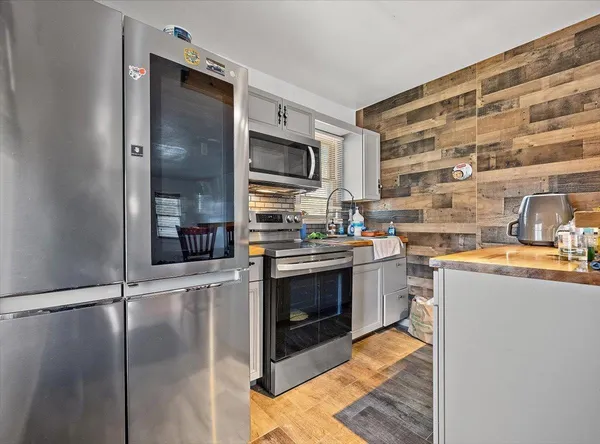 a kitchen with stainless steel appliances granite countertop a stove and a sink
