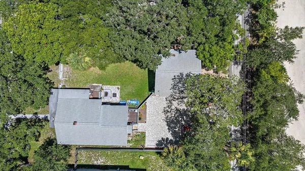 an aerial view of a house with yard and outdoor seating