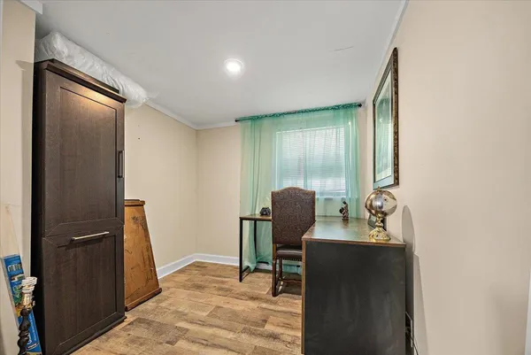 a dining room with furniture and wooden floor