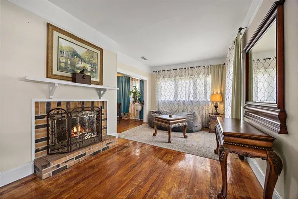 a view of a dining room with furniture wooden floor and chandelier