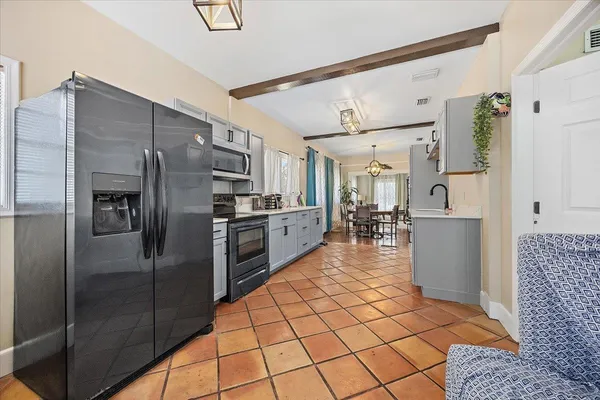 a large kitchen with a sink and cabinets