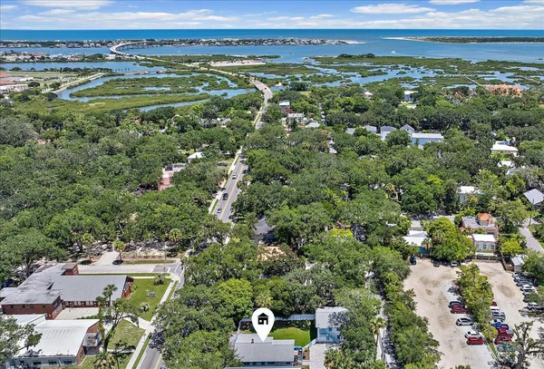 an aerial view of a houses with a yard