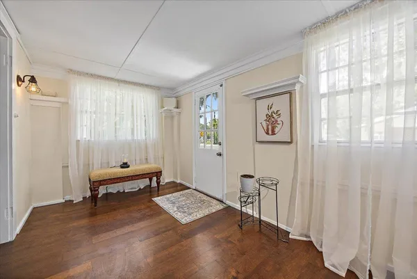 a view of a bedroom with furniture window and wooden floor