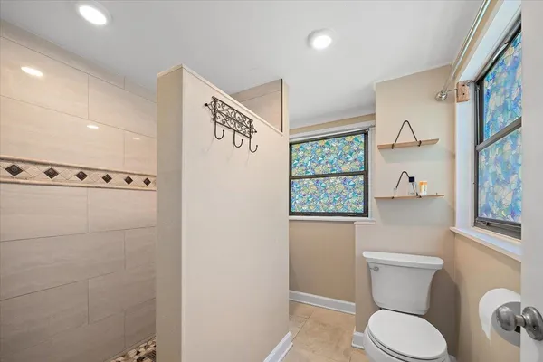 a white toilet sitting next to a bathroom sink