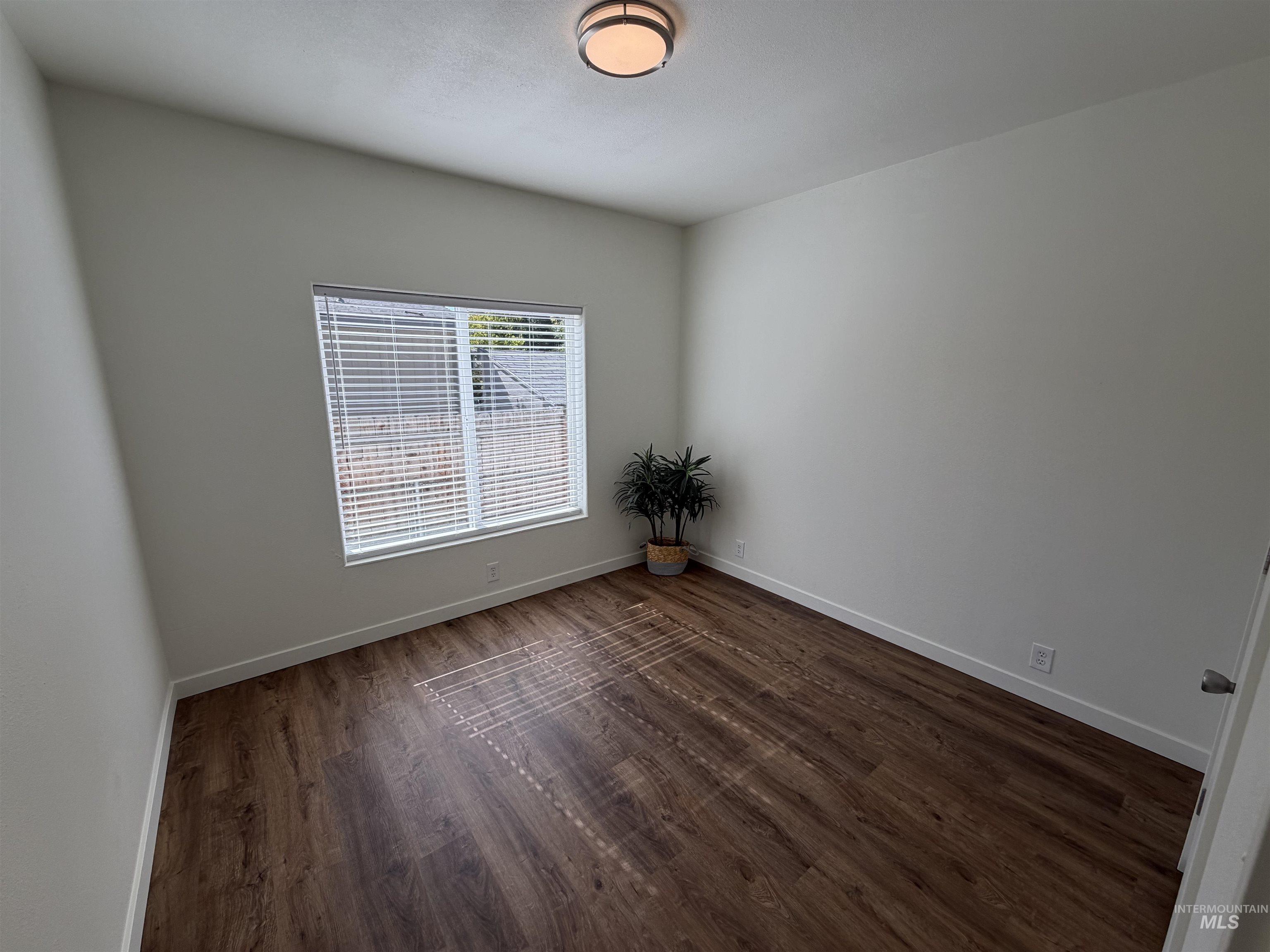 611 North Timathy Road Boise, ID 83713 - Photo 25 of 28 Wood-finish flooring, white walls, and a contemporary ceiling light fixture