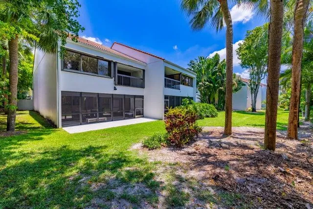 a view of a house with backyard porch and sitting area