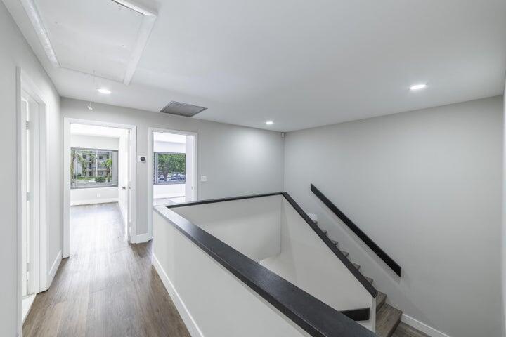 2517 Presidential Way, Unit B West Palm Beach, FL 33401 - Photo 13 of 45 a view of an empty room with wooden floor and a window