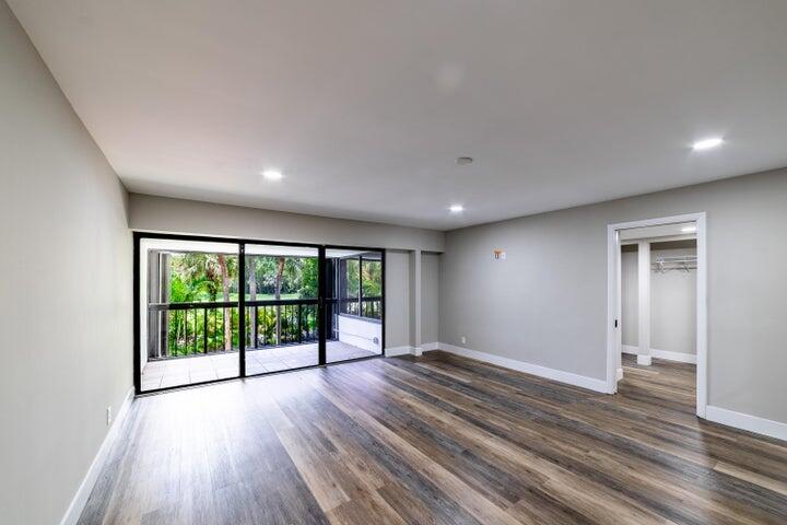 2517 Presidential Way, Unit B West Palm Beach, FL 33401 - Photo 17 of 45 wooden floor in an empty room with a window