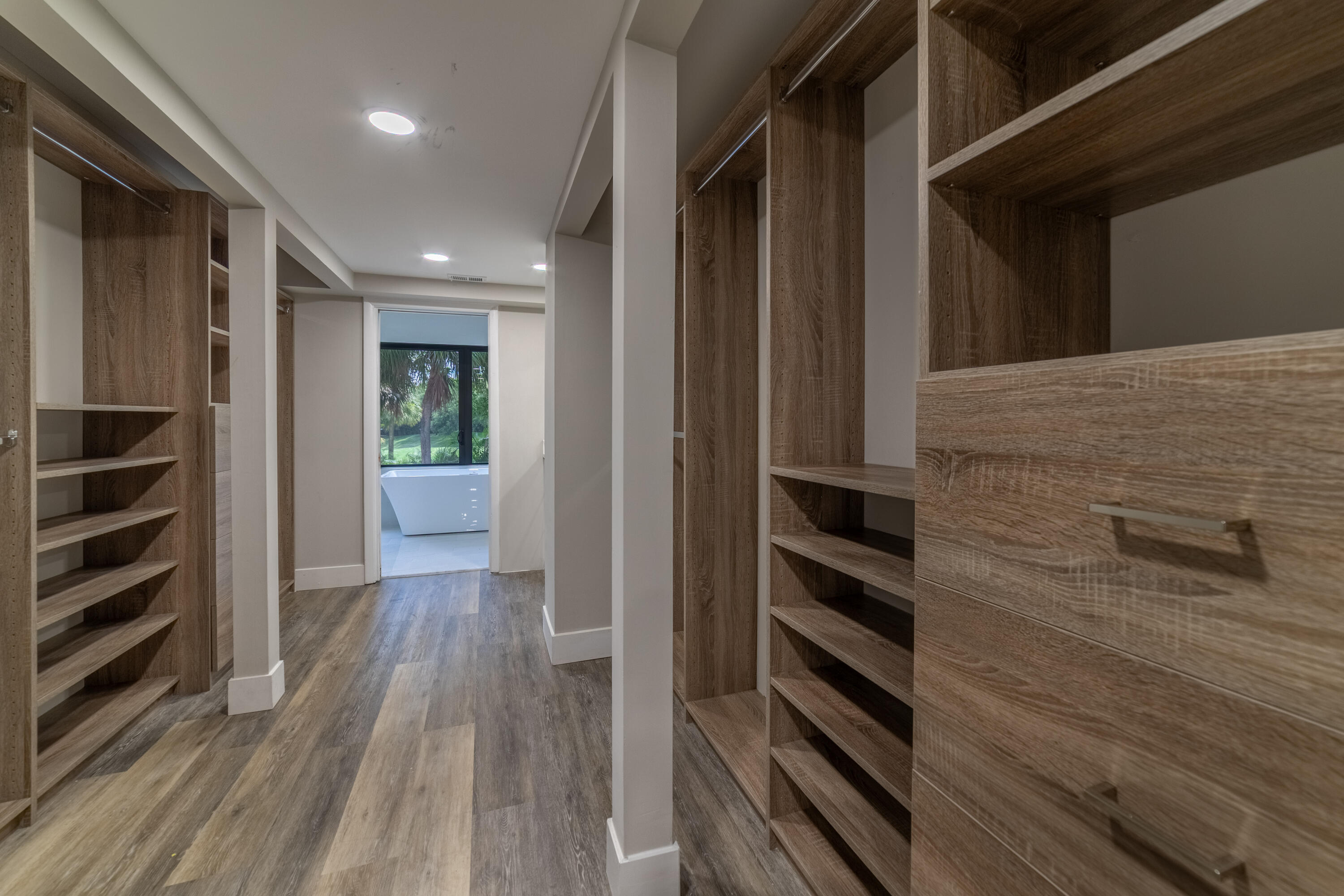 2517 Presidential Way, Unit B West Palm Beach, FL 33401 - Photo 23 of 45 a view of walk in closet with empty racks