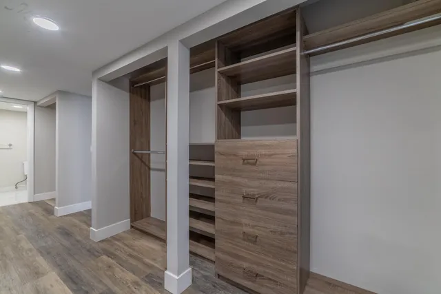 a view of walk in closet with empty racks