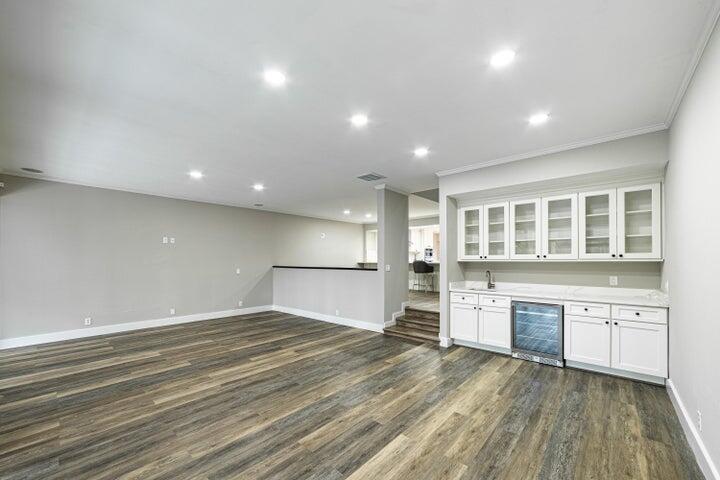 2517 Presidential Way, Unit B West Palm Beach, FL 33401 - Photo 3 of 45 an empty room with a fireplace and wooden floor