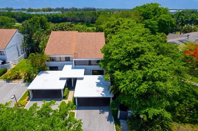 an aerial view of a house with swimming pool and outdoor seating