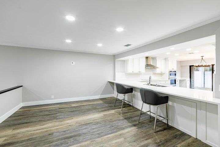 2517 Presidential Way, Unit B West Palm Beach, FL 33401 - Photo 4 of 45 a kitchen with a sink cabinets and wooden floor