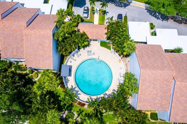 an aerial view of a house with outdoor space and tennis court