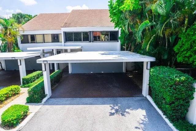a view of a house with a yard and sitting area
