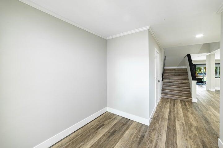2517 Presidential Way, Unit B West Palm Beach, FL 33401 - Photo 7 of 45 a view of a hallway with wooden floor