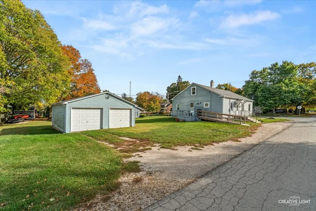 a front view of house with yard and green space