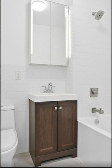 1115 Hancock Street Brooklyn, NY 11221 - Photo 16 of 33 a bathroom with a sink vanity and toilet