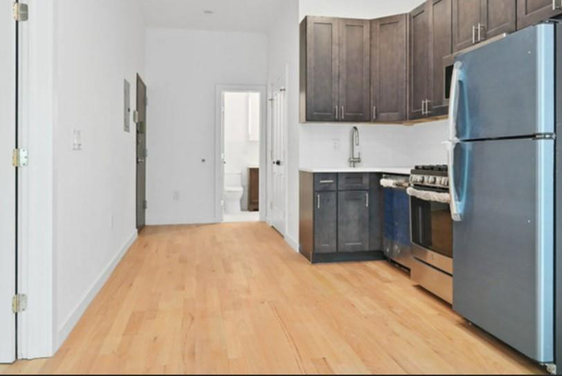1115 Hancock Street Brooklyn, NY 11221 - Photo 22 of 33 a kitchen with a refrigerator and a stove top oven