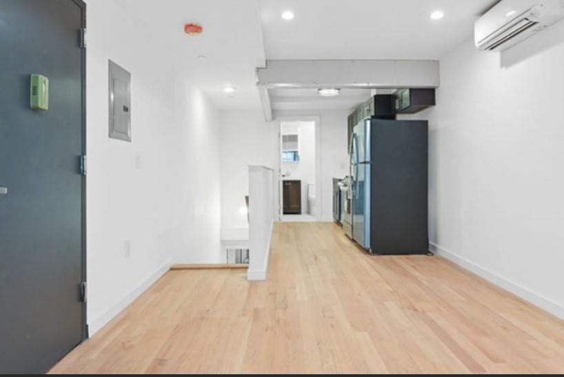 1115 Hancock Street Brooklyn, NY 11221 - Photo 27 of 33 a view of a hallway with wooden shelves