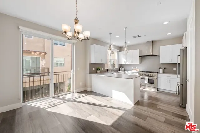 a large white kitchen with granite countertop lots of counter top space