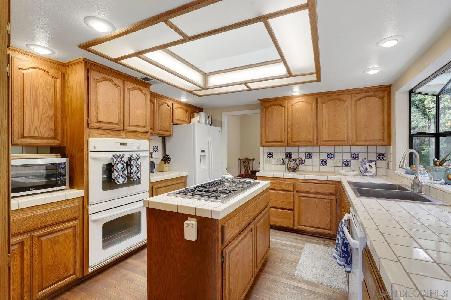 3944 Pala Mesa Drive Fallbrook, CA 92028 - Photo 14 of 39 a kitchen with a stove sink and refrigerator