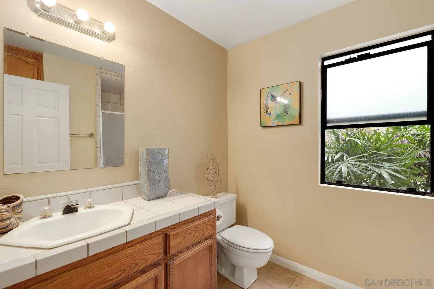 3944 Pala Mesa Drive Fallbrook, CA 92028 - Photo 26 of 39 a bathroom with a toilet sink and mirror