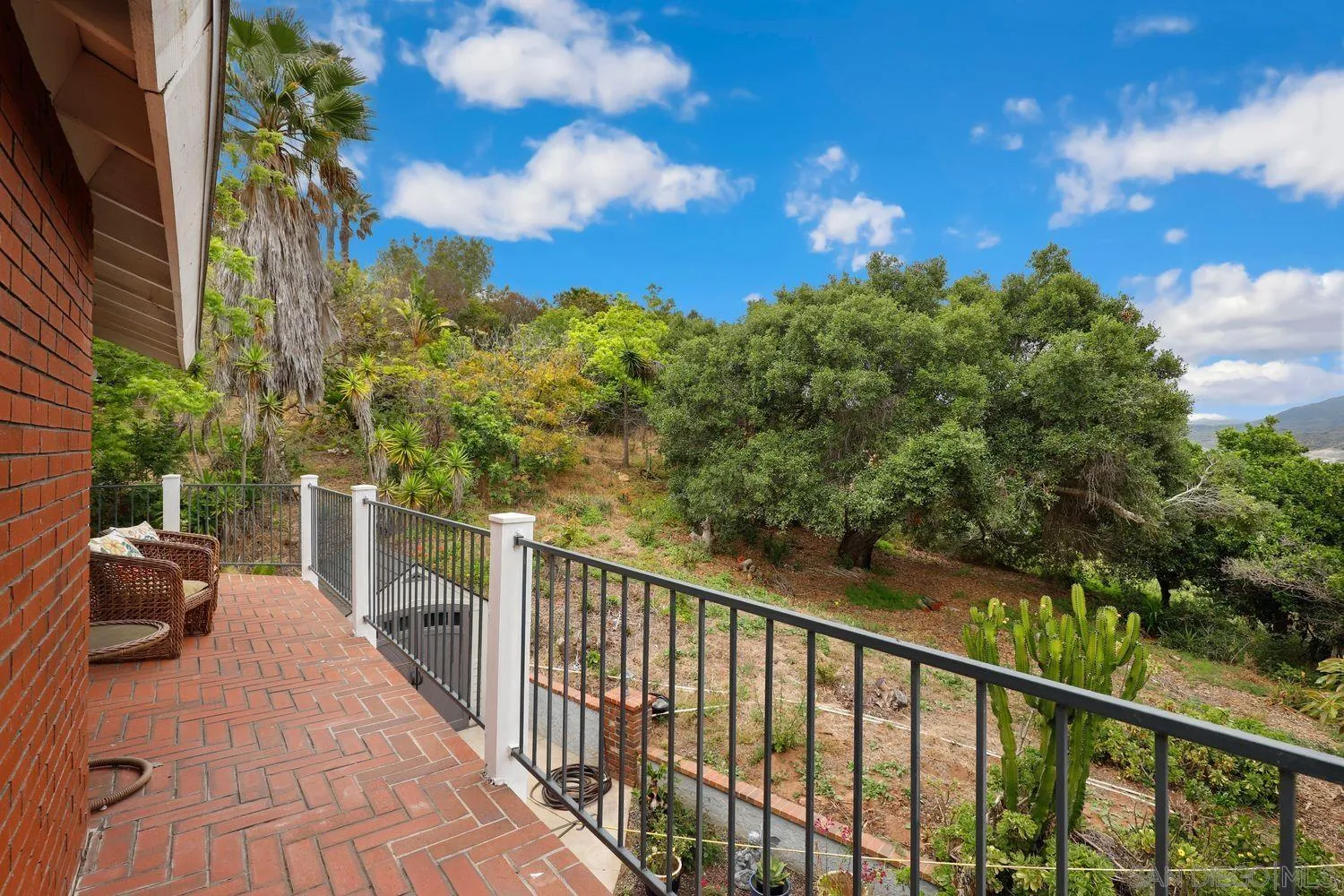 3944 Pala Mesa Drive Fallbrook, CA 92028 - Photo 31 of 39 a view of a balcony with chair and wooden fence