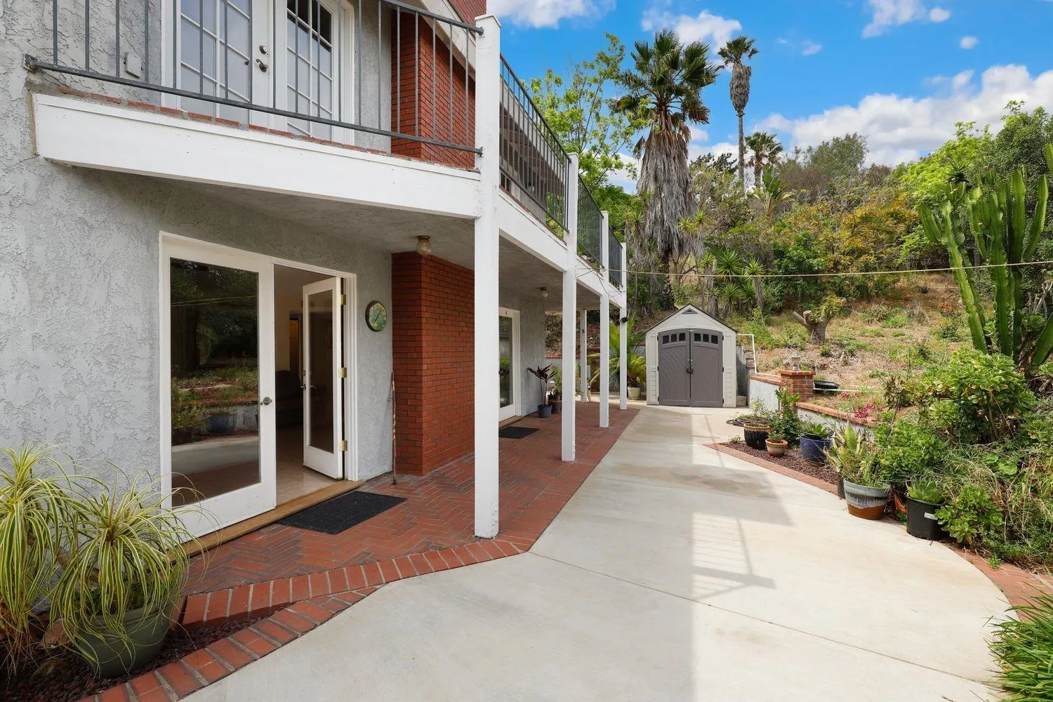 3944 Pala Mesa Drive Fallbrook, CA 92028 - Photo 32 of 39 a view of a house with a potted plant and floor to ceiling window and potted plants
