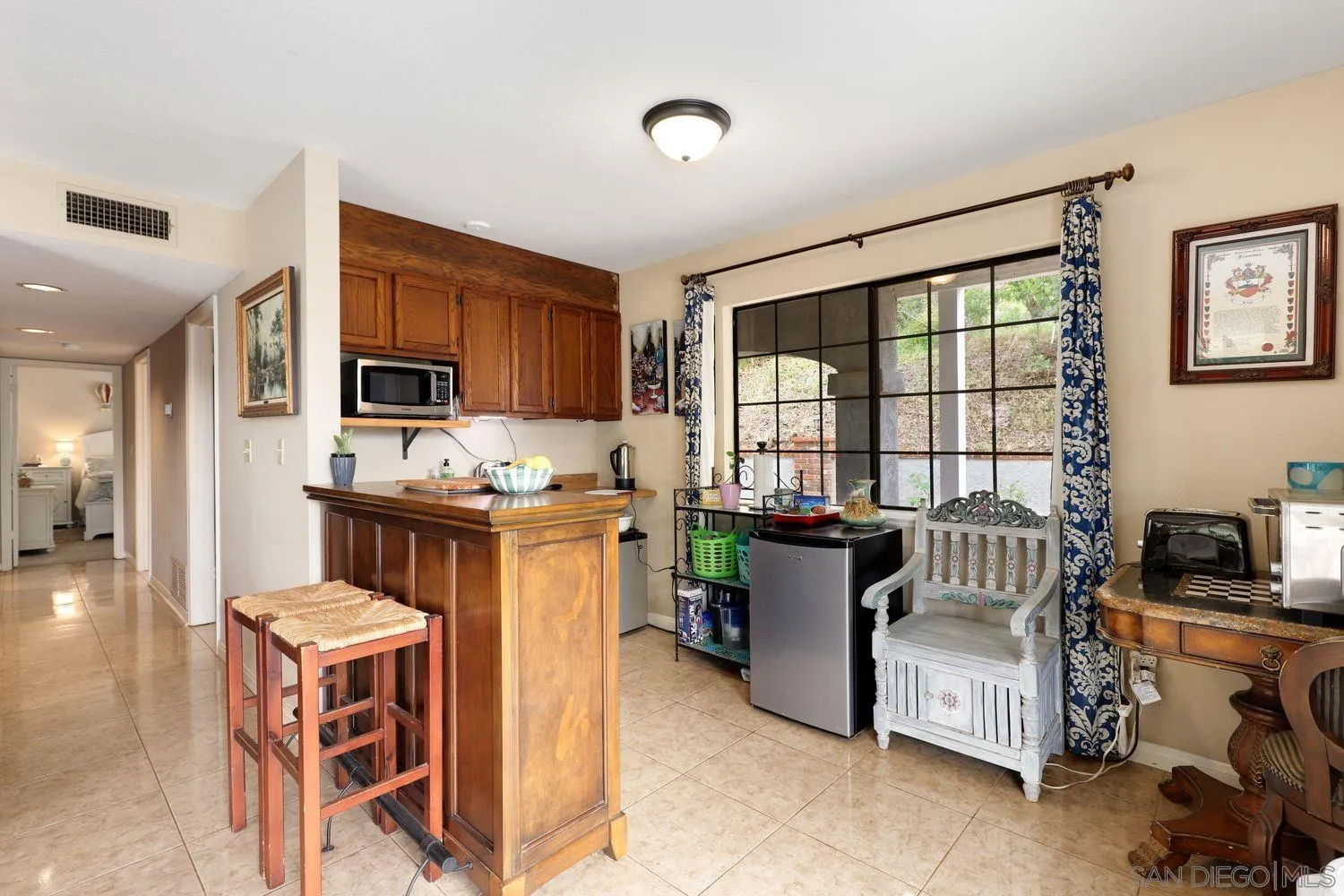 3944 Pala Mesa Drive Fallbrook, CA 92028 - Photo 8 of 39 a living room with furniture a flat screen tv and a window