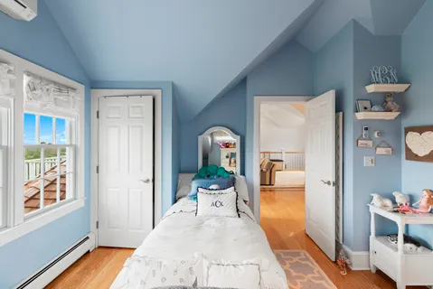 a living room with a bed and a window