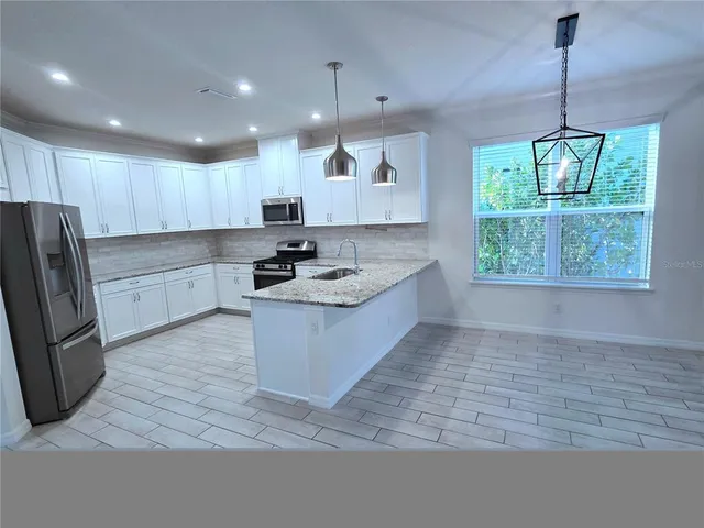 a view of a livingroom with furniture and a window