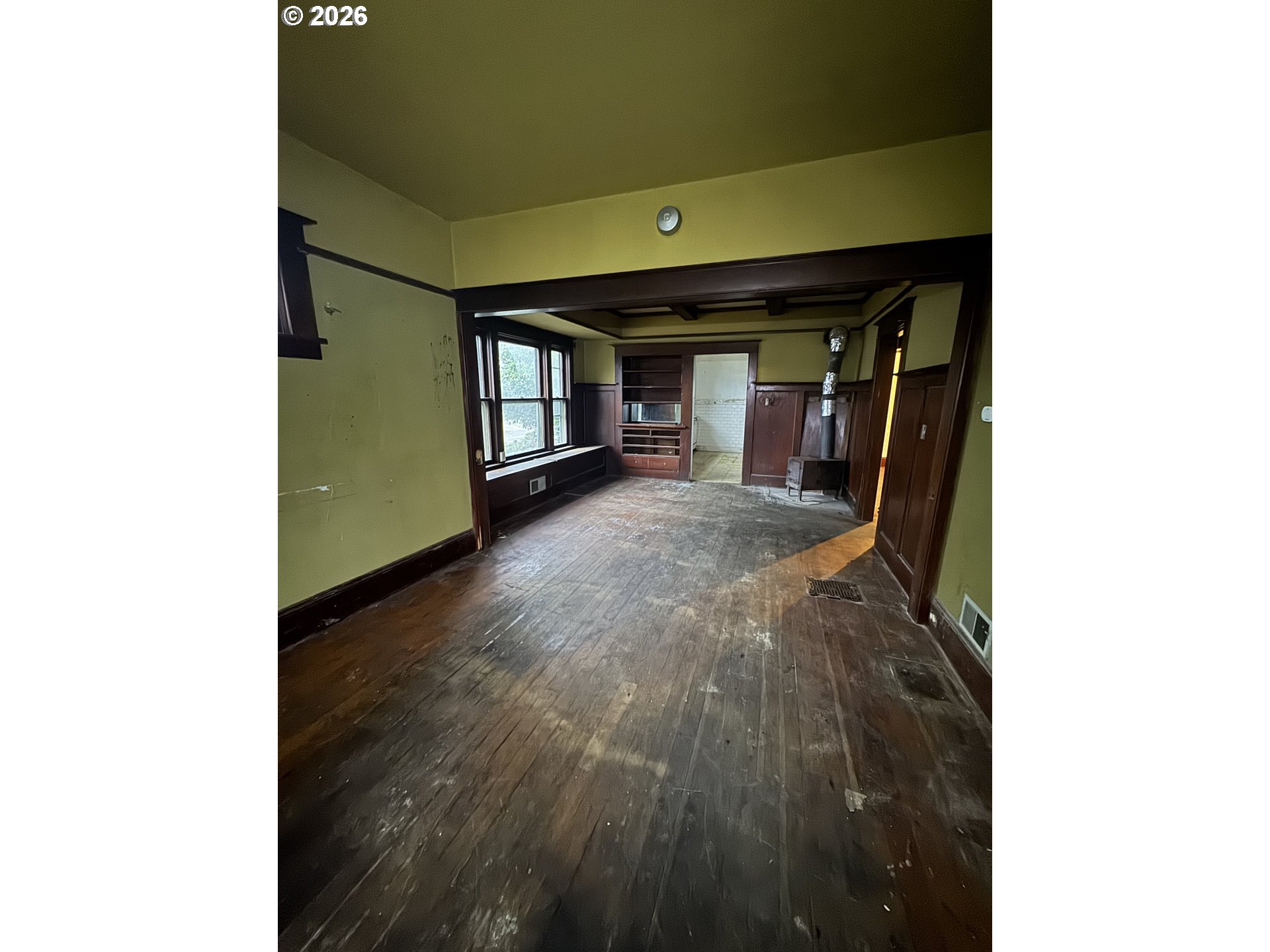 6422 Southeast Carlton Street Portland, OR 97206 - Photo 12 of 27 a view of a hallway with wooden floor and a living room
