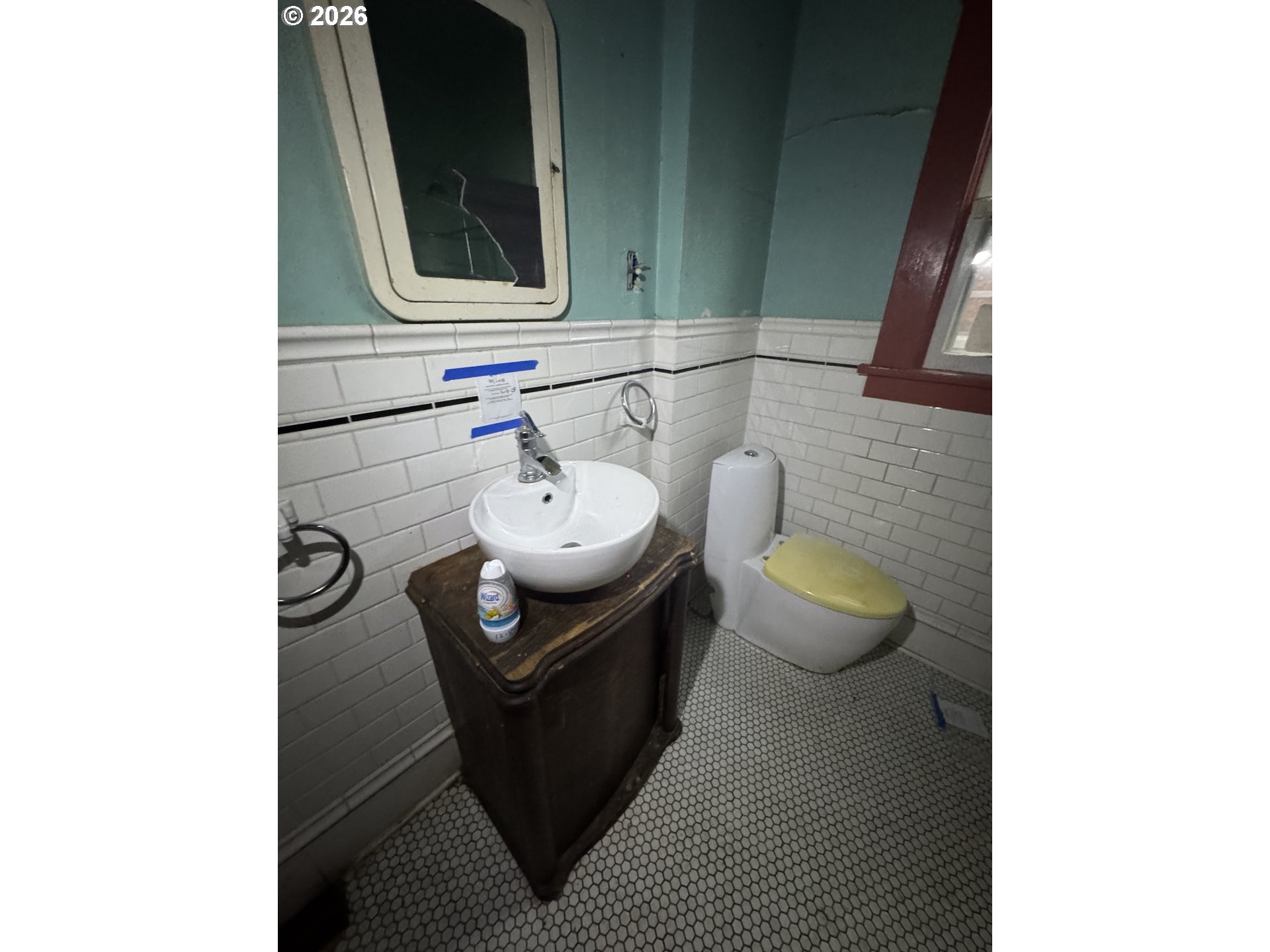 6422 Southeast Carlton Street Portland, OR 97206 - Photo 7 of 27 a bathroom with a toilet a sink and mirror