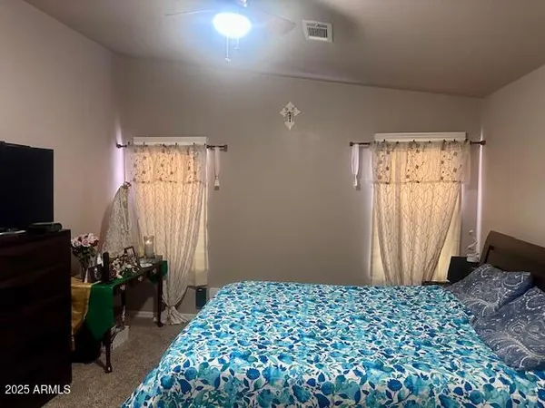 a bedroom with a bed and a window