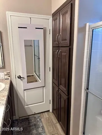 a bathroom with a granite countertop sink a toilet and a mirror