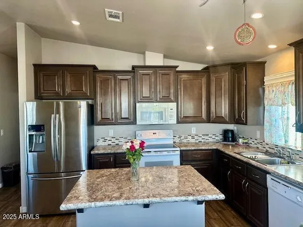a kitchen that has a table and chair in it