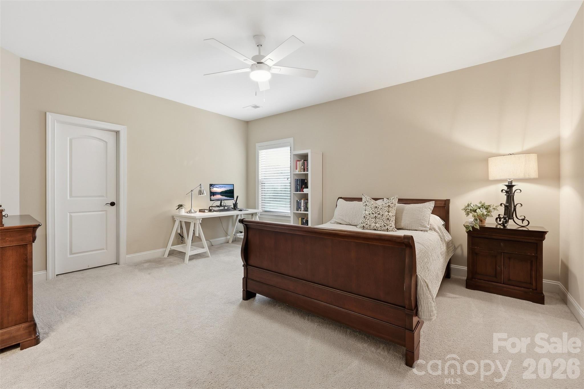 8094 Clems Branch Road Indian Land, SC 29707 - Photo 21 of 38 a spacious bedroom with a bed and a chandelier
