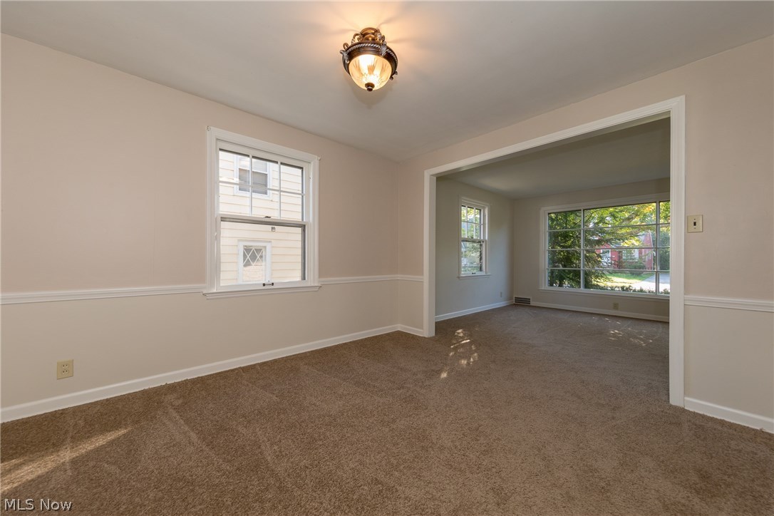 1235 Winston Road Cleveland, OH 44121 - Photo 11 of 30 The spacious Dining Room with fresh paint and new carpet, looking towards the living room at rear
