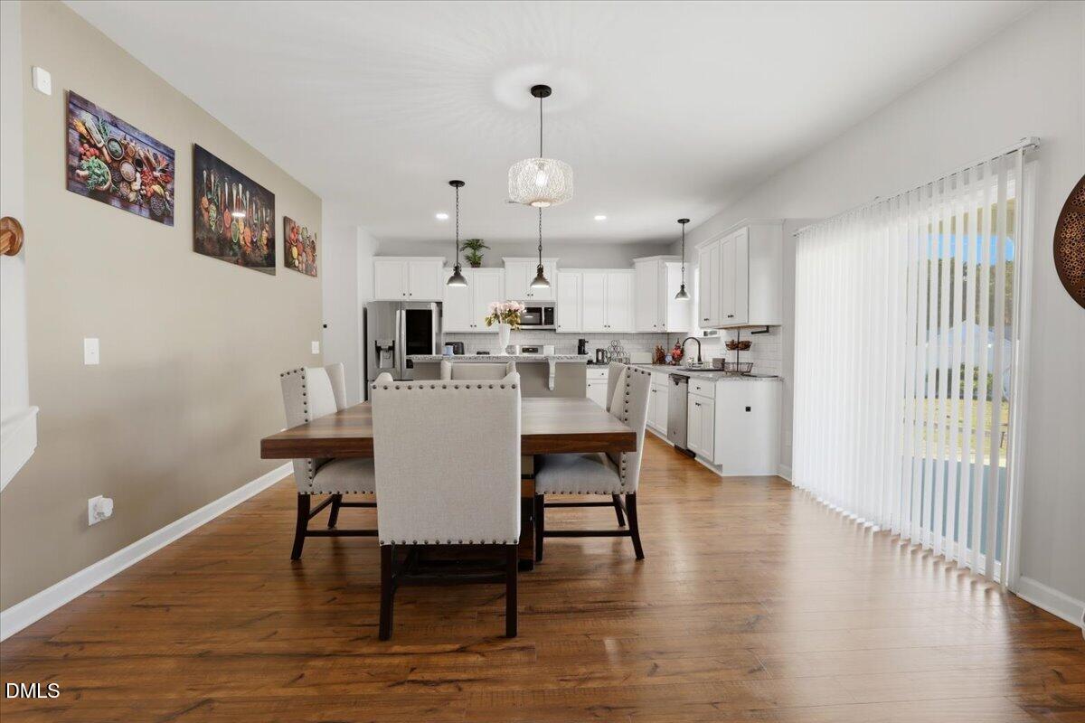 136 Fallingbrook Drive Kenly, NC 27542 - Photo 15 of 54 a view of a dining room with furniture and wooden floor