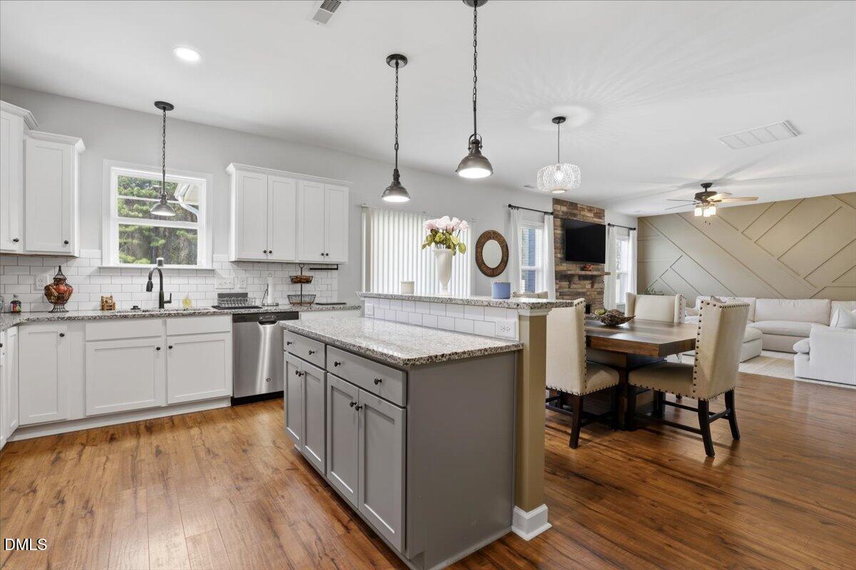 136 Fallingbrook Drive Kenly, NC 27542 - Photo 17 of 54 a kitchen with a stove a window and chairs